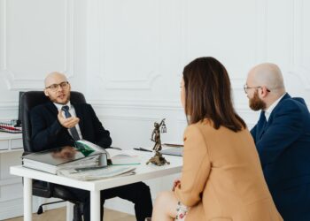 Photo by Photo By: Kaboompics.com: https://www.pexels.com/photo/a-couple-talking-to-a-lawyer-7876315/