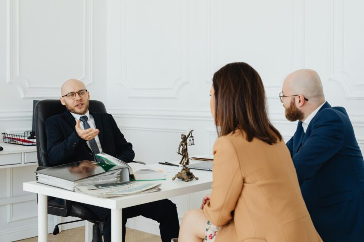 Photo by Photo By: Kaboompics.com: https://www.pexels.com/photo/a-couple-talking-to-a-lawyer-7876315/