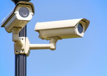 Photo by AS Photography: https://www.pexels.com/photo/white-2-cctv-camera-mounted-on-black-post-under-clear-blue-sky-96612/