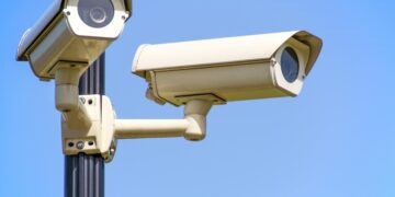 Photo by AS Photography: https://www.pexels.com/photo/white-2-cctv-camera-mounted-on-black-post-under-clear-blue-sky-96612/