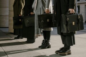 Photo by cottonbro studio: https://www.pexels.com/photo/people-holding-leather-bags-6535356/