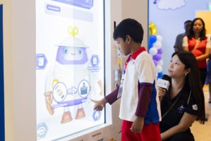 PHOTO PCF Sparkletots Preschool student interacting with WonderBot 2.0 at the Children's Museum Singapore