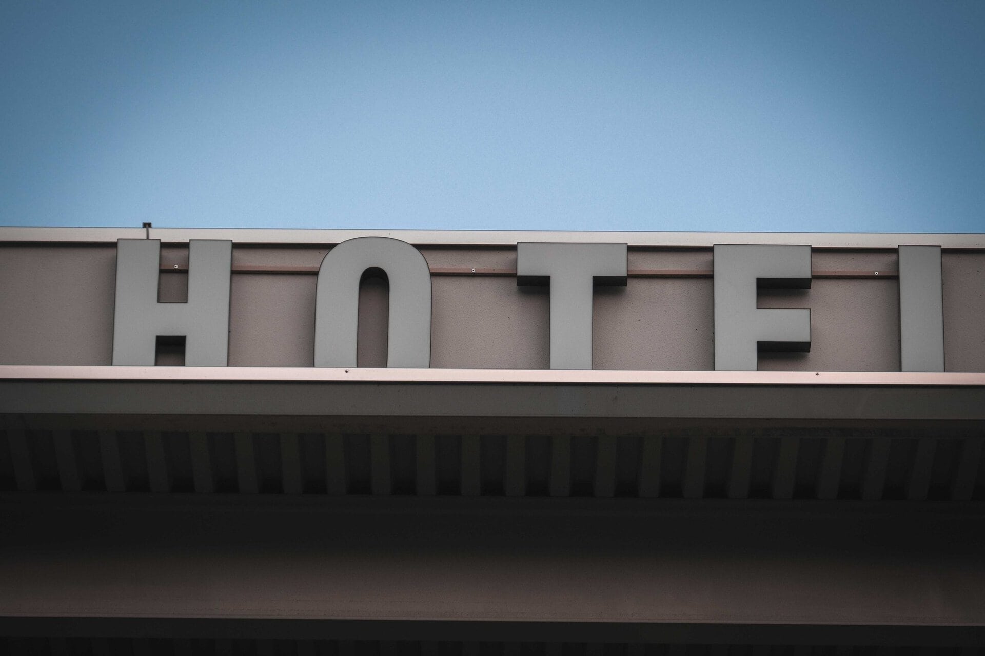 Photo by Francesco Ungaro: https://www.pexels.com/photo/facade-of-modern-hotel-building-under-blue-sky-7380282/