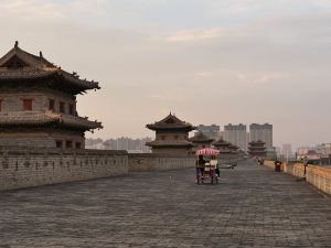 Photo by Rain Lü: https://www.pexels.com/photo/cyclists-on-xian-city-wall-at-sunset-28678711/