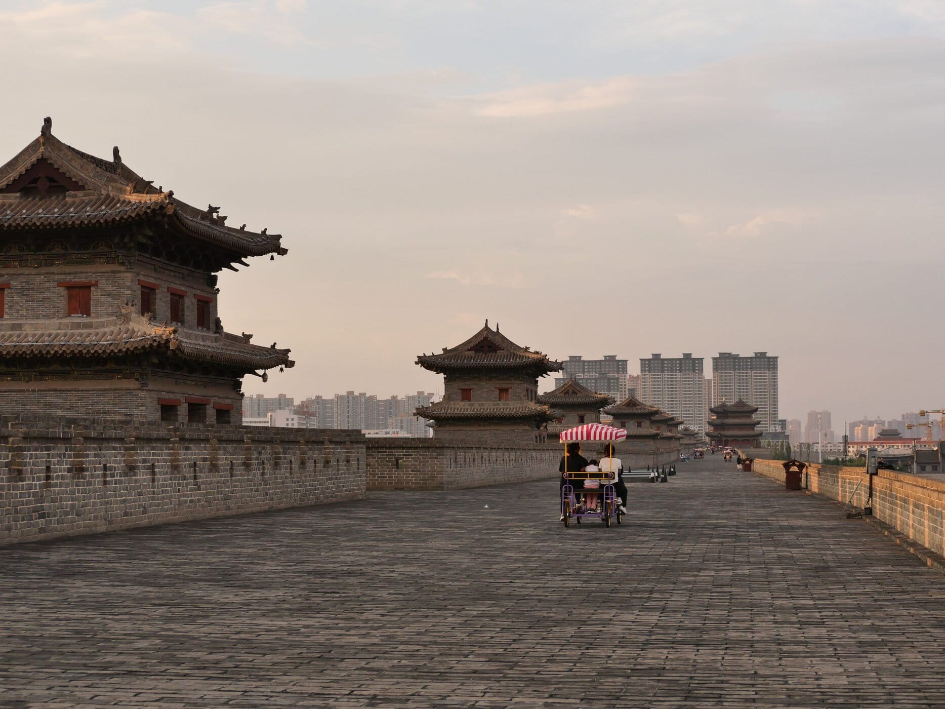 Photo by Rain Lü: https://www.pexels.com/photo/cyclists-on-xian-city-wall-at-sunset-28678711/