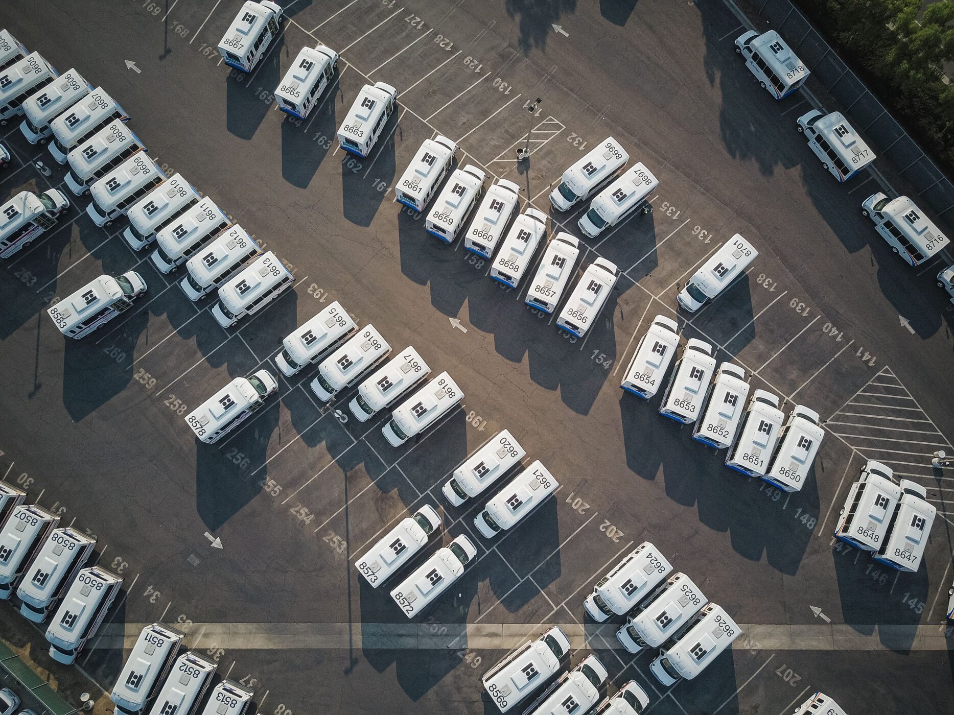 Photo by Kindel Media: https://www.pexels.com/photo/top-view-shot-of-vehicles-on-an-open-parking-lot-9716240/